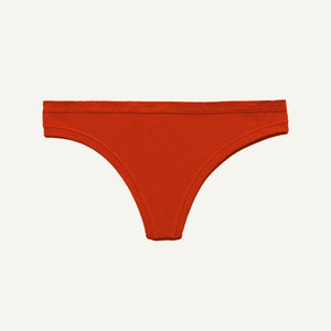 A bright orange-red thong-style underwear bottom shown flat against a light off-white background.