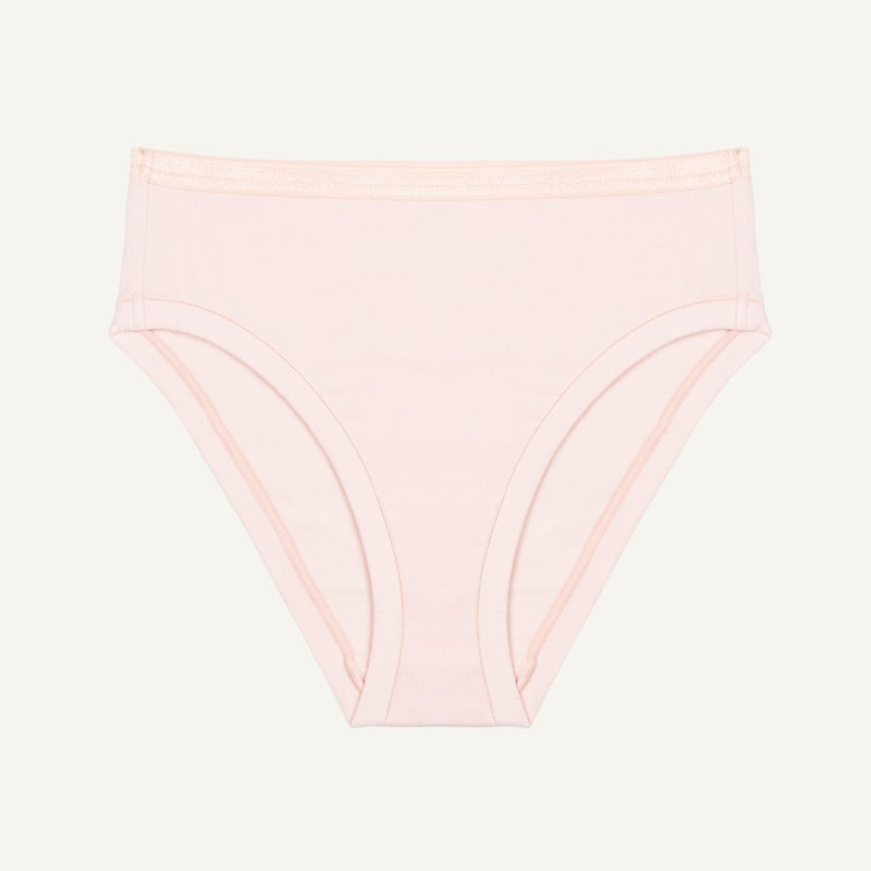 A mid-rise bikini brief in a light pink quartz color made from organic cotton.