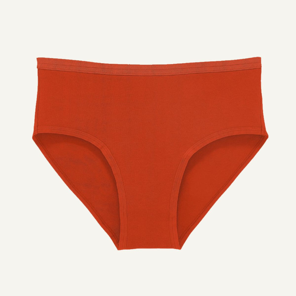 A pair of solid rust-orange briefs shown flat against a light off-white background.