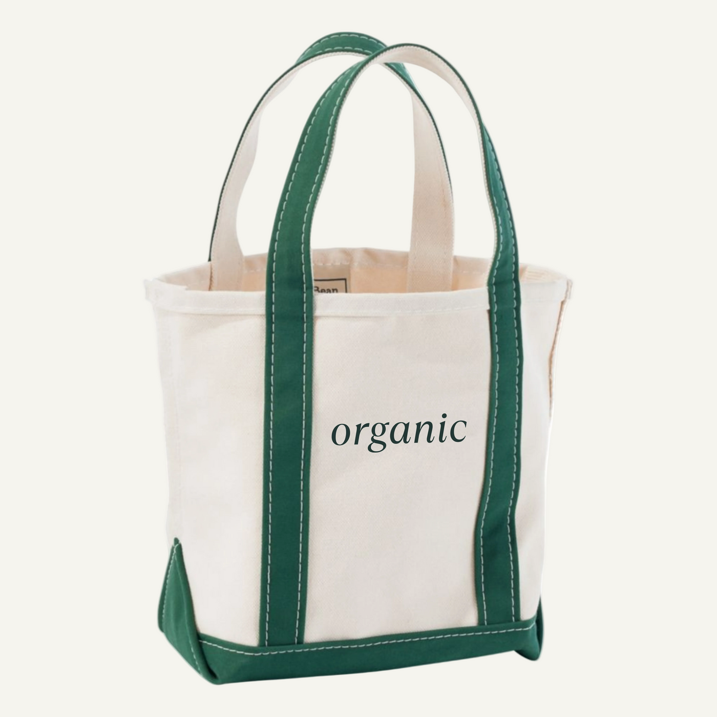 Tote bag with green handles and trim, featuring the word 'organic' on a light beige background.